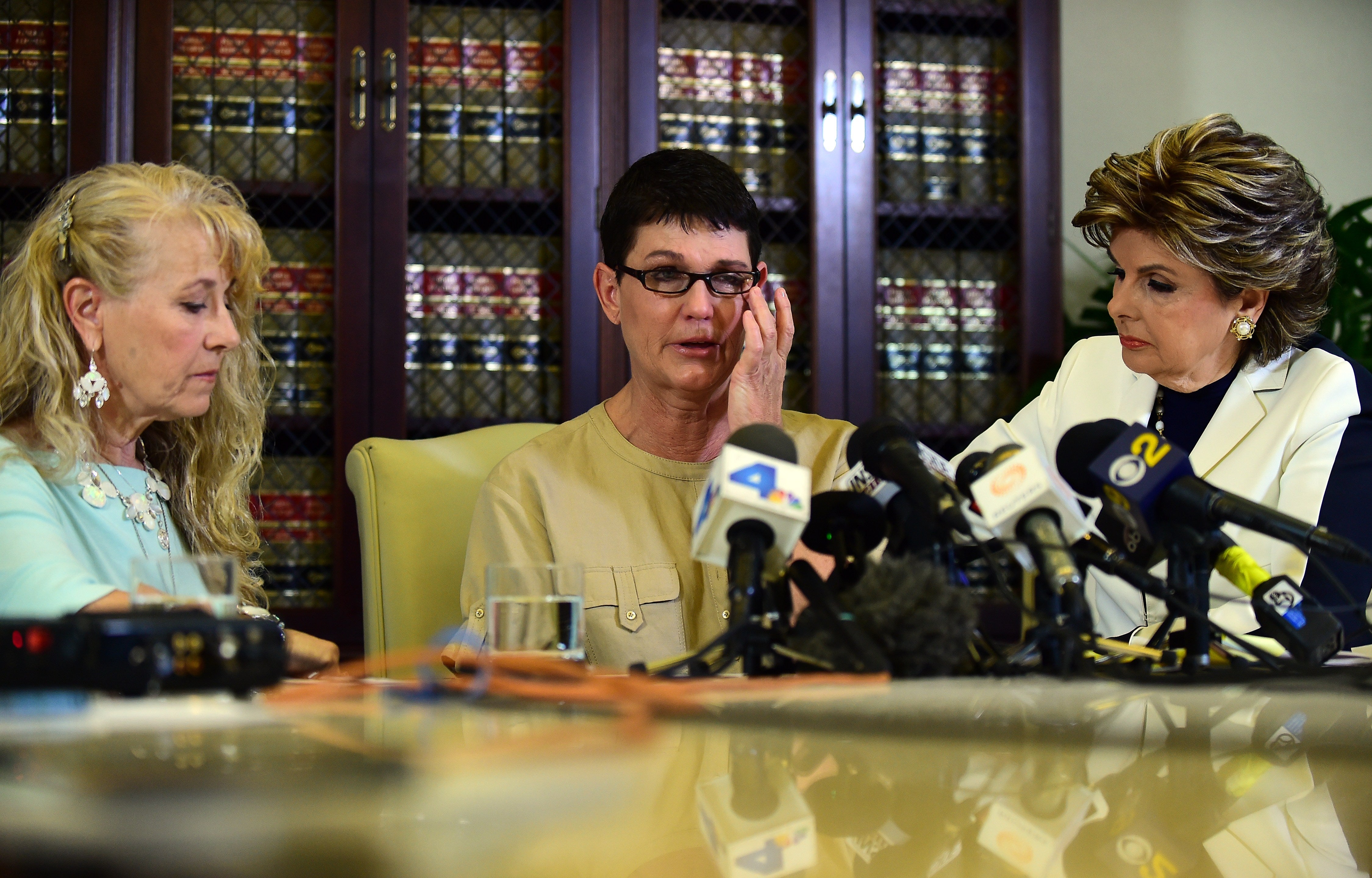 File image: Beth Ferrier reacts while speaking seated between attorney Gloria Allred and Rebecca Lynn Neal