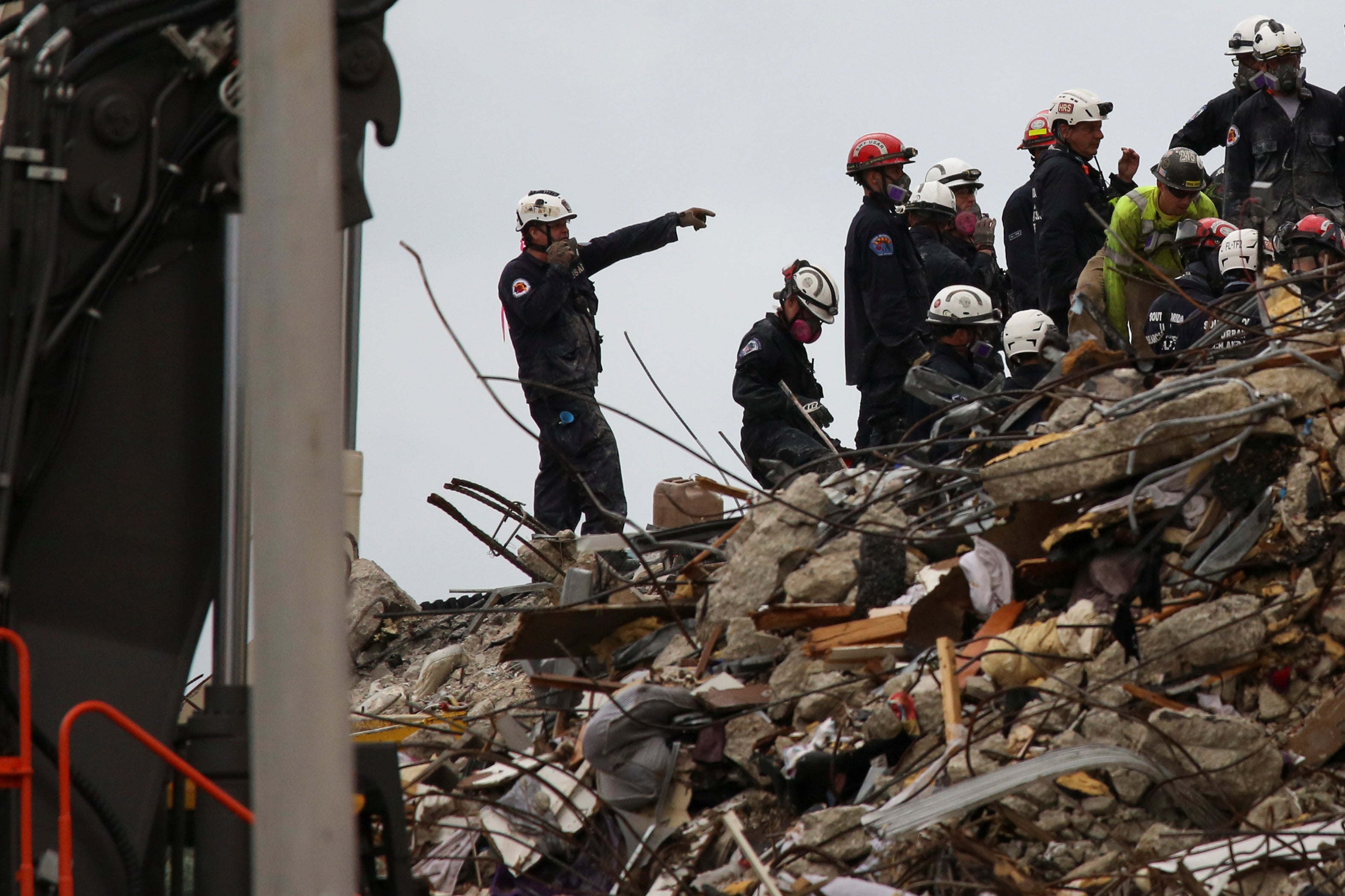 Rescue personnel continue the search and rescue operation at the site of the partially collapsed building in Surfside on 30 June, 2021