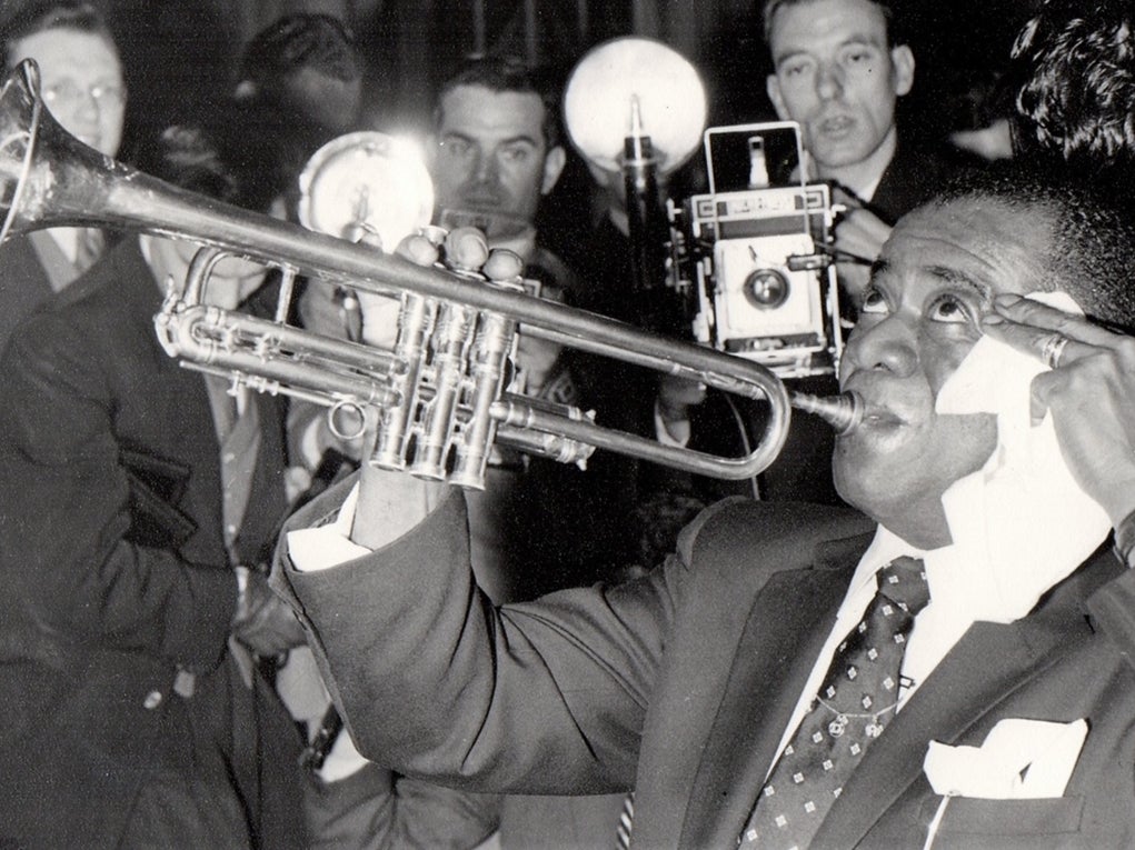 Louis Armstrong in London, 1956, with future biographer John Chilton far left