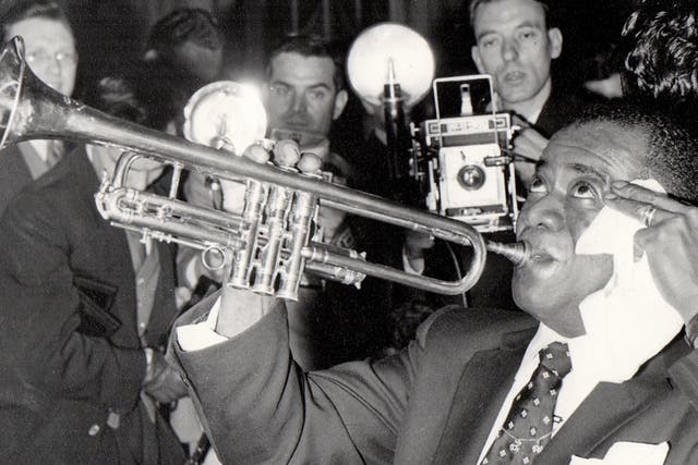 <p>Louis Armstrong in London, 1956, with future biographer John Chilton far left</p>