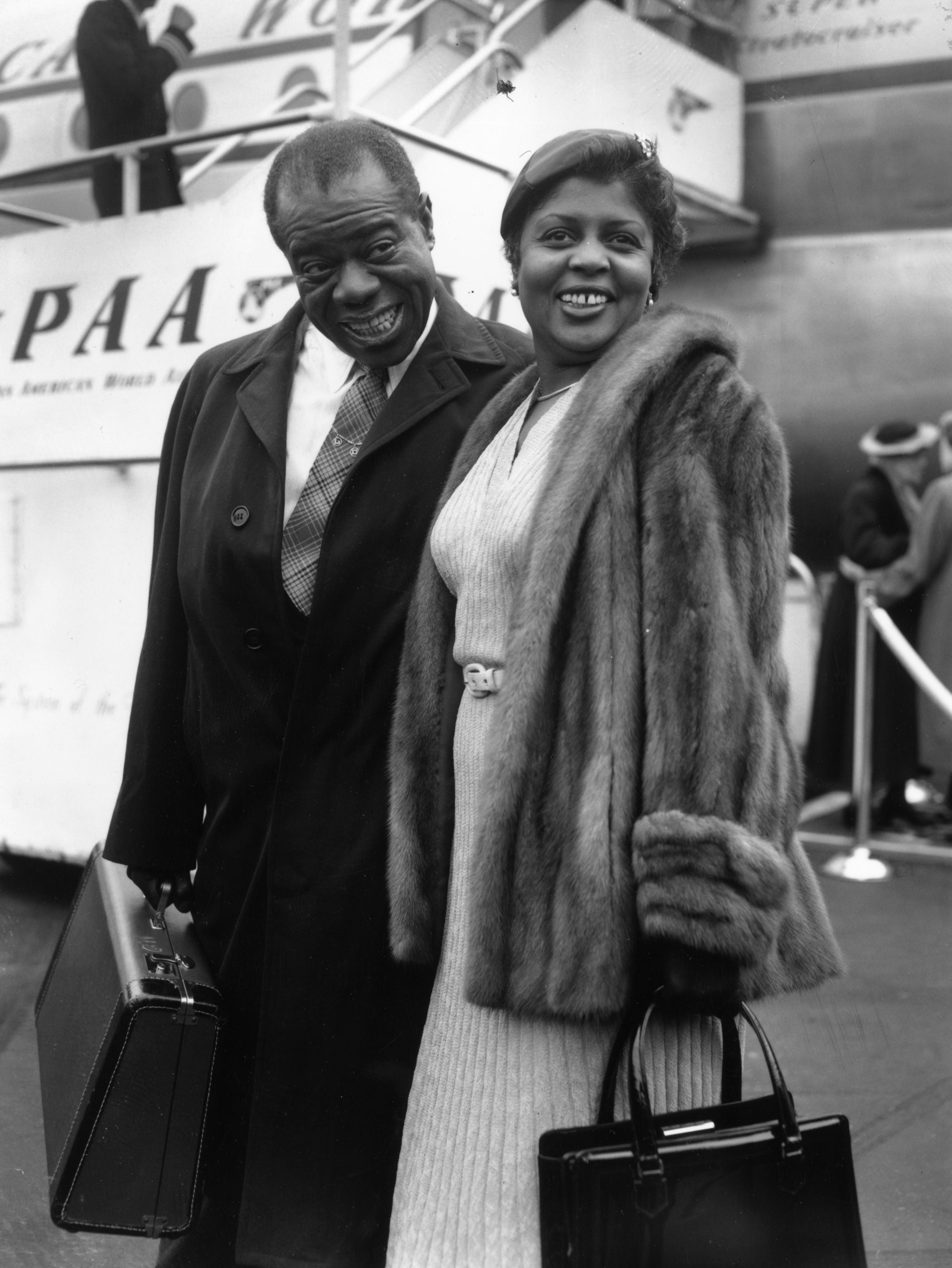 Louis Armstrong with his wife, Lucille, at London Airport in 1956