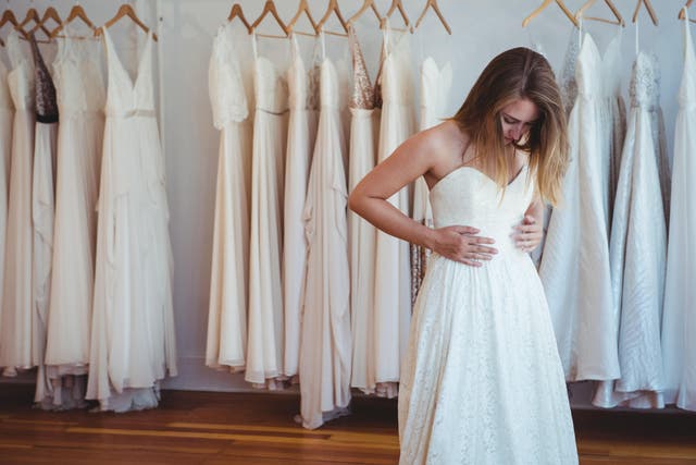 Woman trying on wedding dress in a shop
