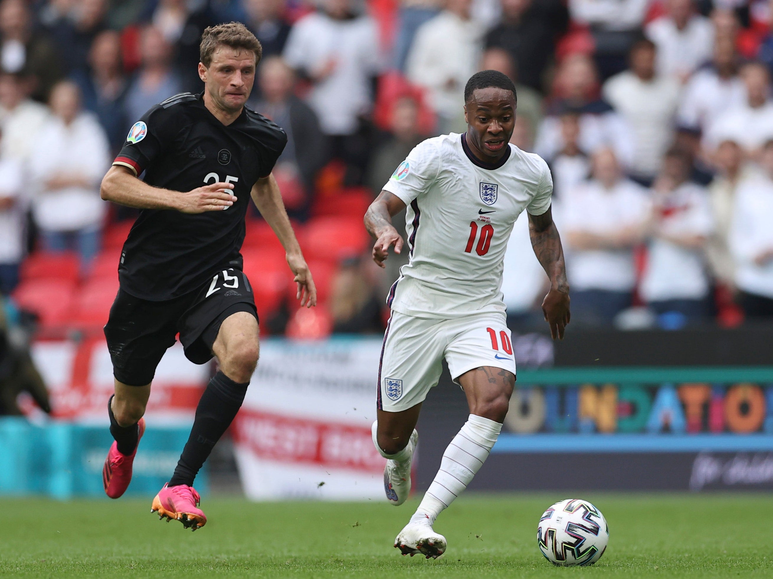 Raheem Sterling is challenged by Thomas Mueller when England met Germany at Wembley on Tuesday