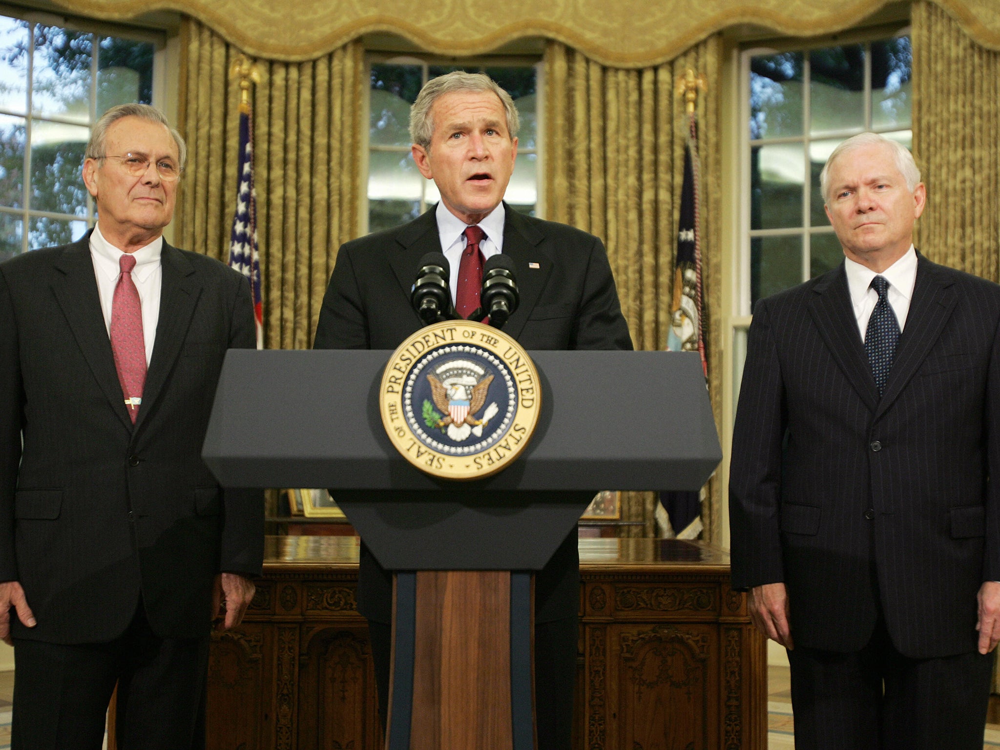 With George W Bush and his defence secretary replacement Robert Gates (right) in 2006