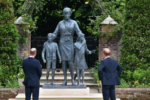 <p>The Duke of Cambridge (left) and Duke of Sussex look at the statue they commissioned of Diana, in the Sunken Garden at Kensington Palace</p>