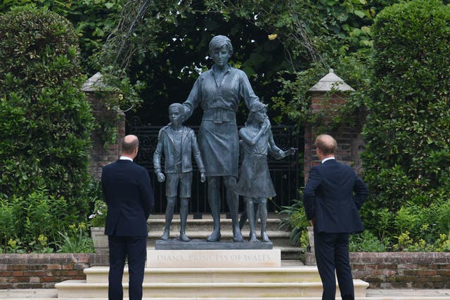 <p>The Duke of Cambridge (left) and Duke of Sussex look at a statue they commissioned of their mother Diana, Princess of Wales, in the Sunken Garden at Kensington Palace, London, on what would have been her 60th birthday</p>
