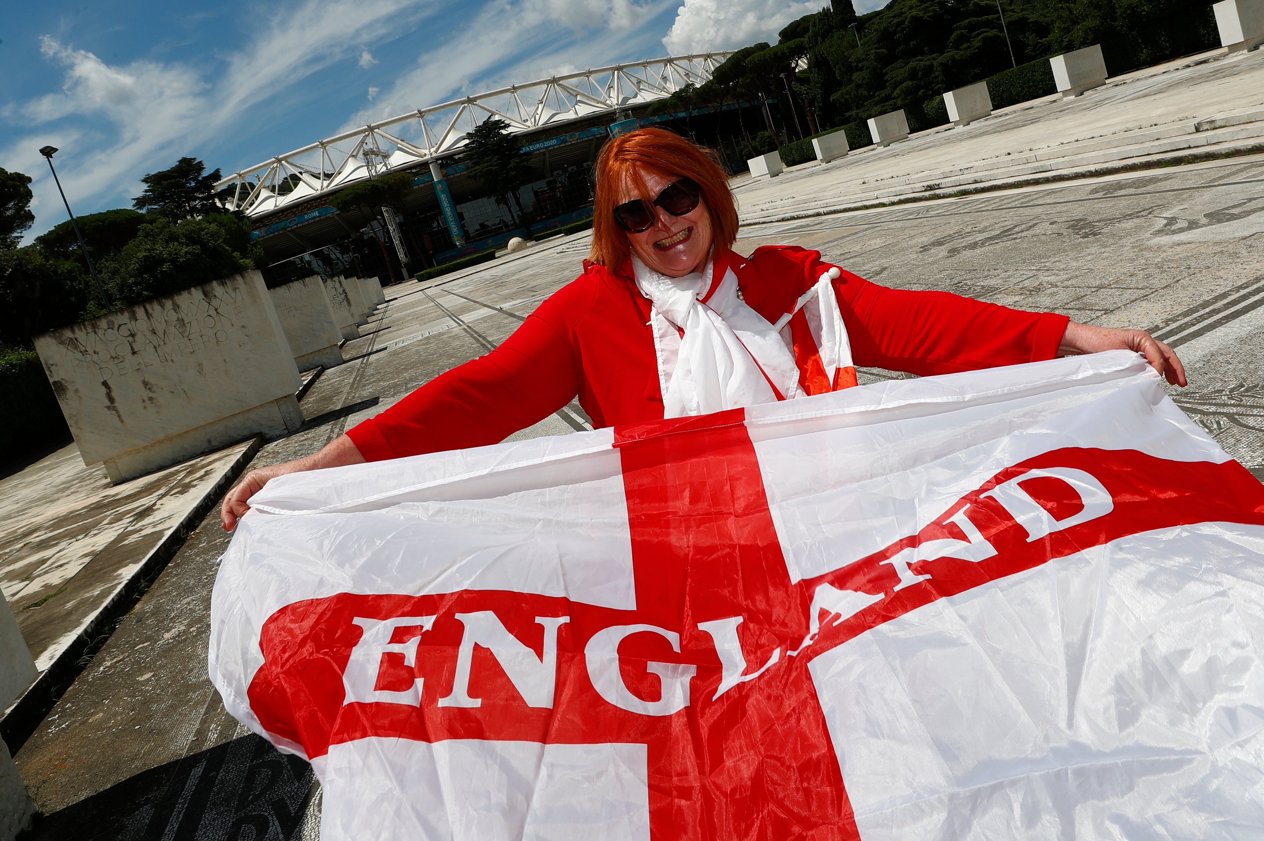England soccer fan Dawn Hughes, who lives and works in Italy, poses for a photograph before the Euro 2020 quarter final against Ukraine, outside Stadio Olimpico in Rome
