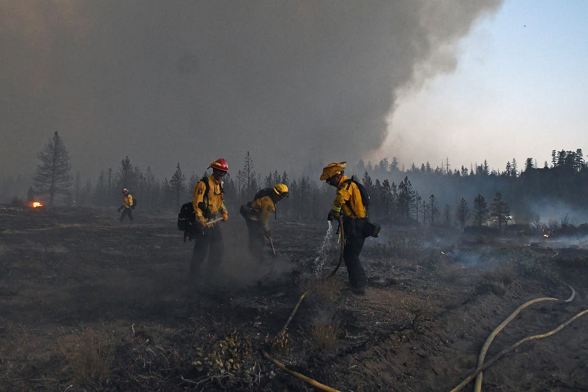 California firefighters battle big wildfires in high heat