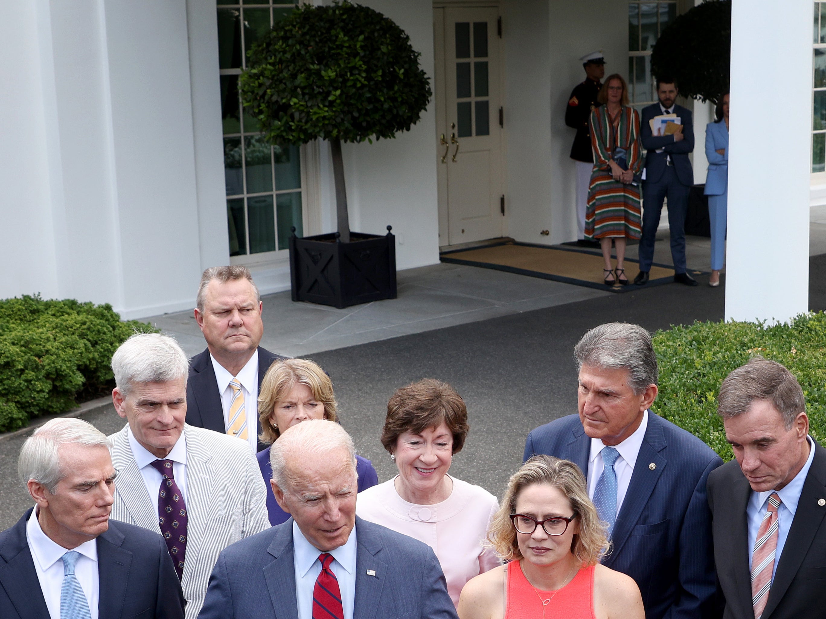 Kamala Harris watches on closely in the background as Joe Biden makes presidential announcements
