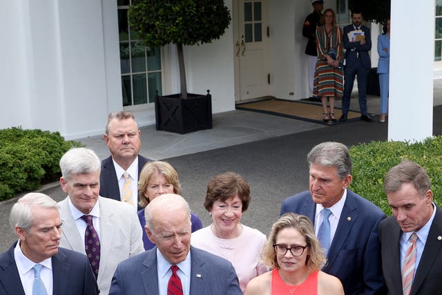 <p>Kamala Harris watches on closely in the background as Joe Biden makes presidential announcements</p>