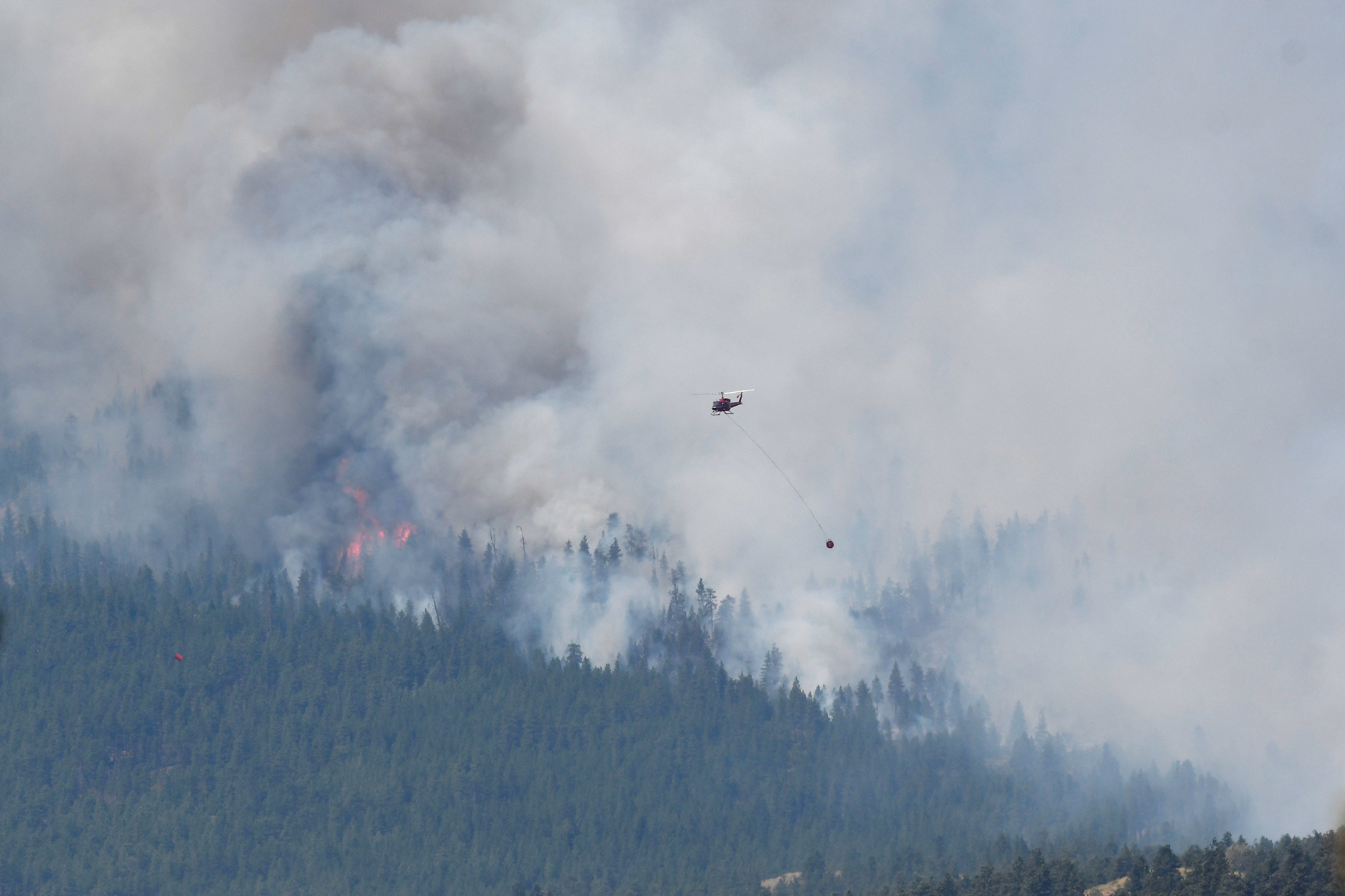 A wildfire burns on 1 July, 2021, outside the British Columbia town of Lytton, which has been gutted by flames.