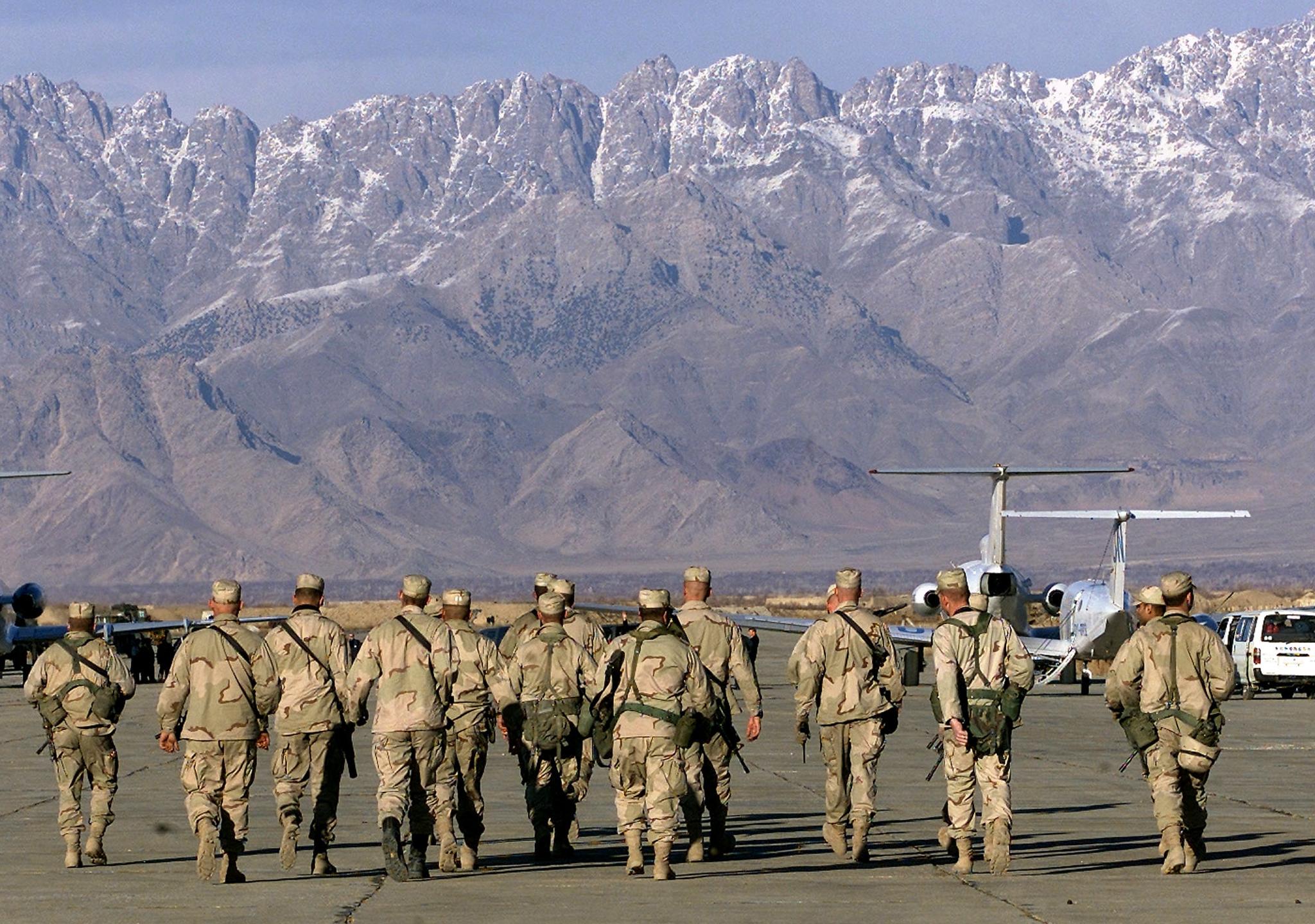 American soldiers approach UN planes on the tarmac of Bagram airbase on 15 January 2002 in this file photo