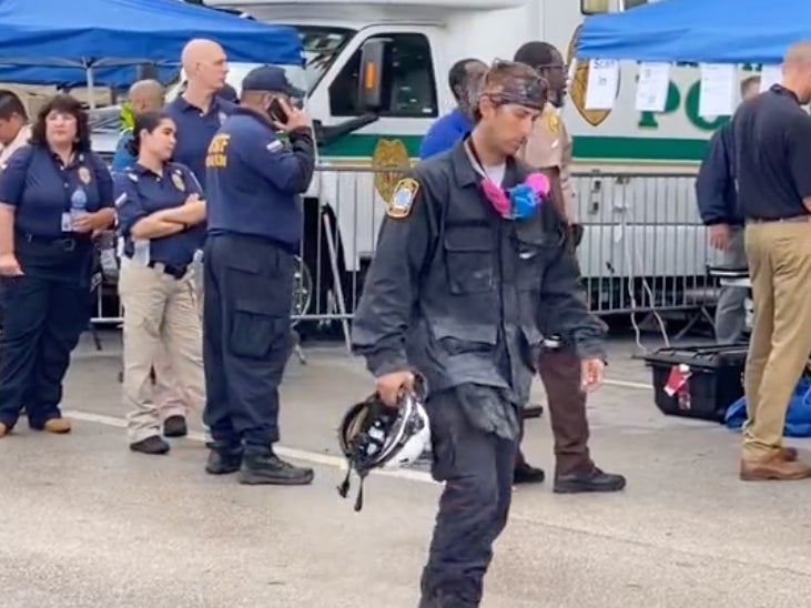 A video posted to TikTok on Wednesday, 30 June, 2021, shows a seemingly exhausted worker walking away from the scene at the partially-collapsed Champlain Towers South condominium in Surfside, Florida.