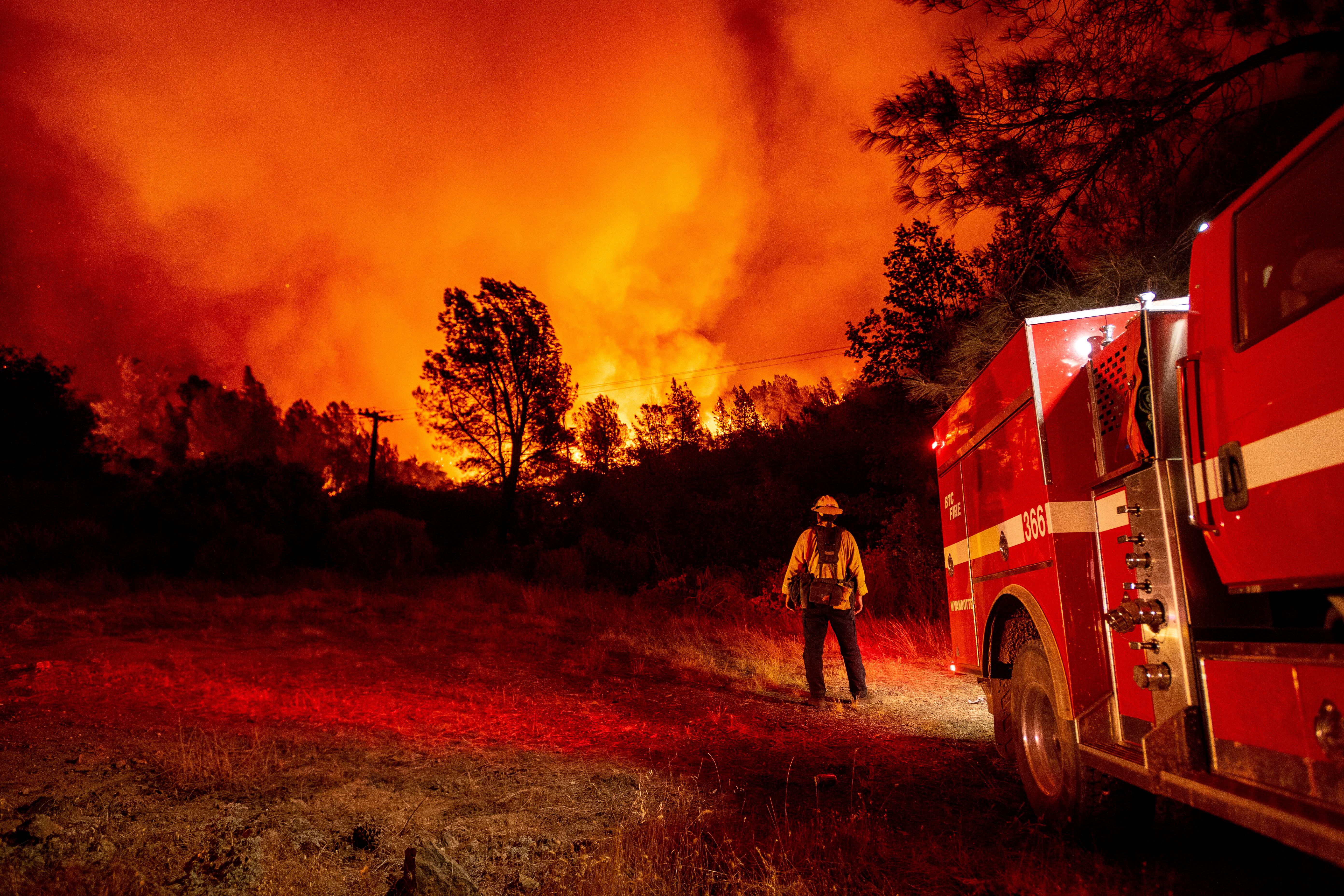 A firefighter watching the approaching blaze in Oroville, California after hundreds of people were evacuated from the area
