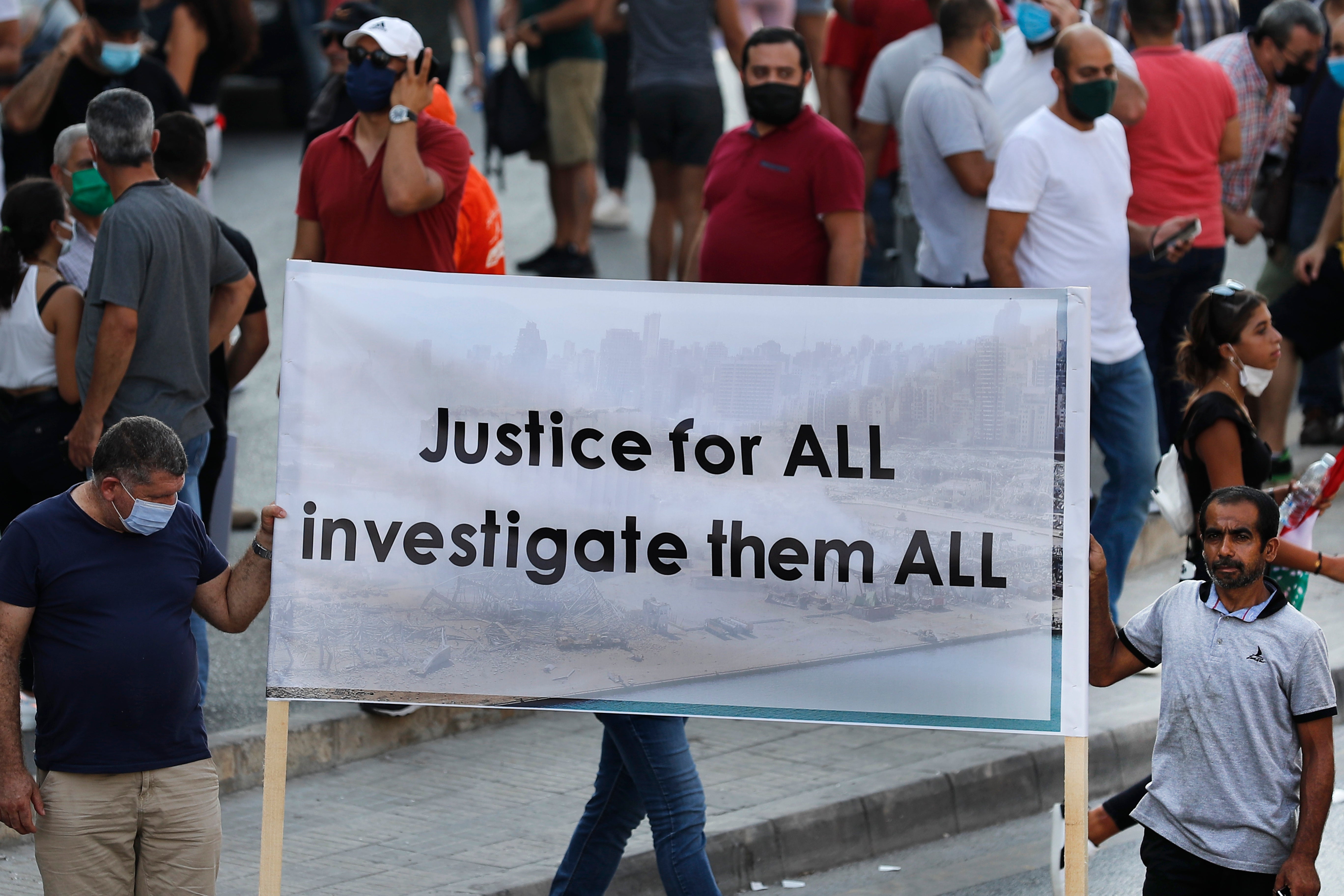 Lebanese supporters of President Michel Aoun hold a banner during a protest calling for "truth and justice" in relation to the Aug. 4 explosion that devastated Beirut port and parts of the Lebanese capital