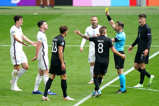 <p>Referee Danny Makkelie shows a yellow card to England’s Declan Rice</p>