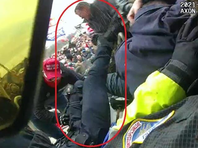 <p>Police body camera footage of Capitol rioter Clayton Mullins dragging a police officer into the crowd of insurrectionists</p>