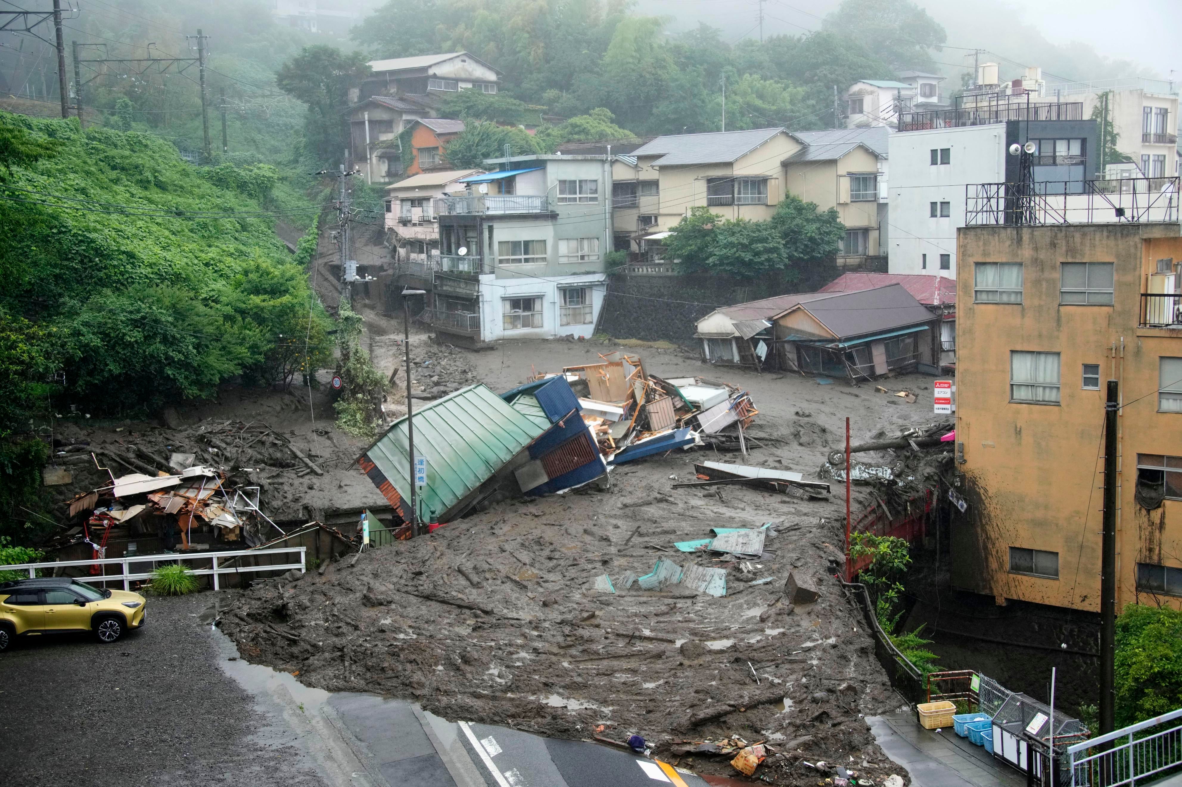 Houses are damaged by mudslide following heavy rain at Izusan district in Atami, west of Tokyo