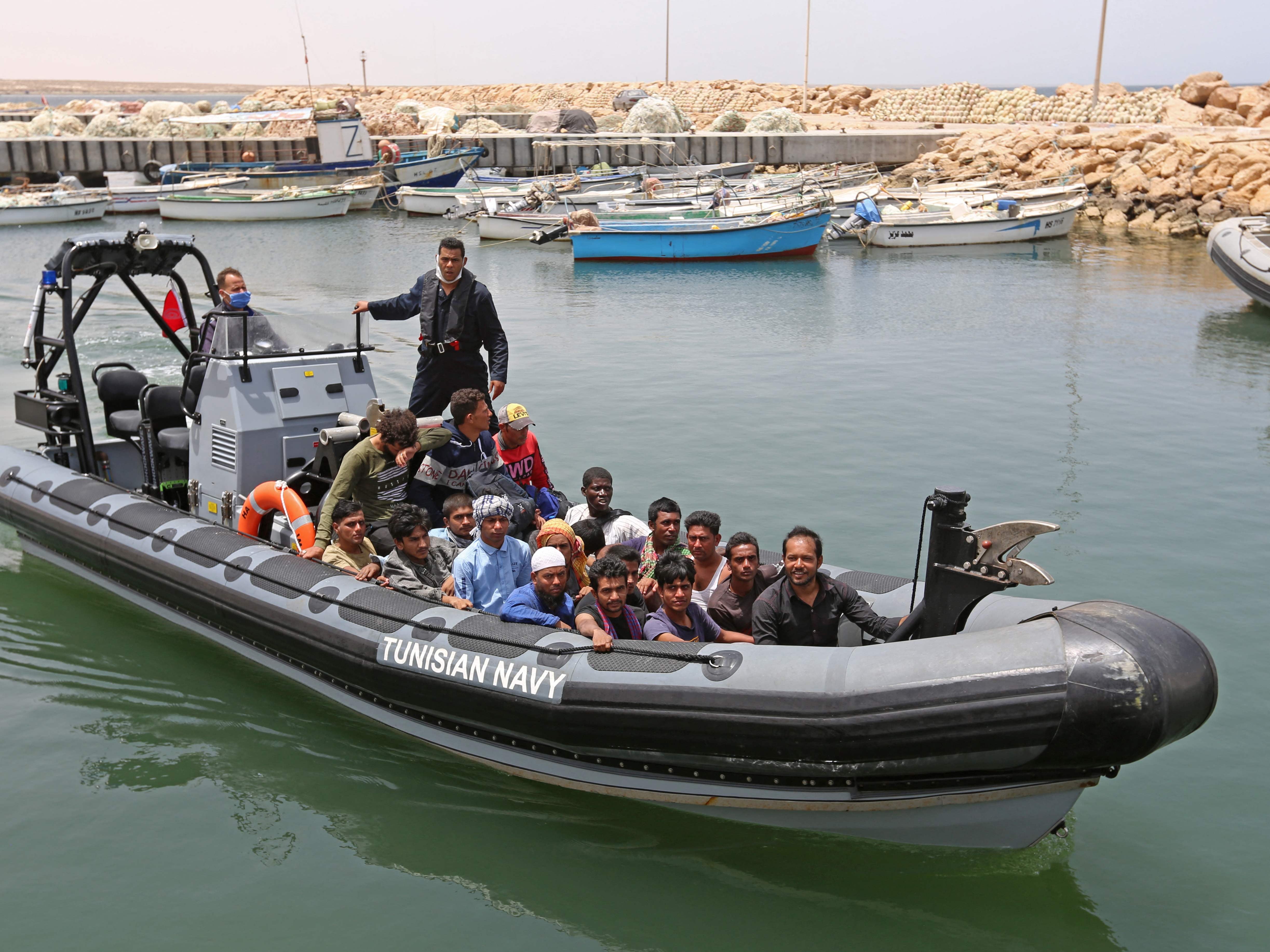 A group of migrants arrive at a port in southern Tunisia after being rescued during an attempted crossing of the Mediterrean on 27 June 2021