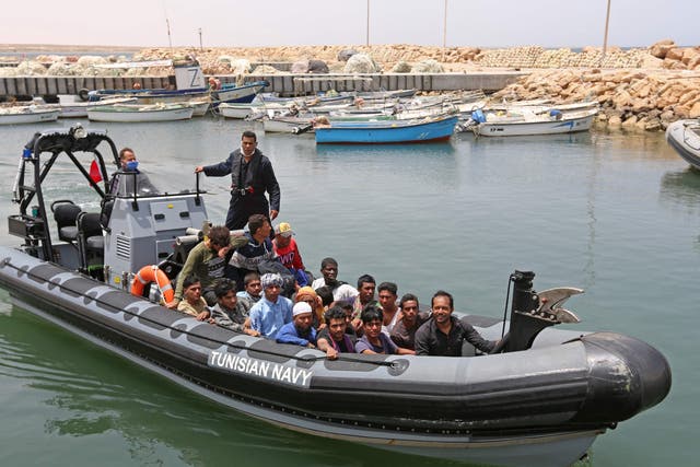 <p>A group of migrants arrive at a port in southern Tunisia  after being rescued during an attempted crossing of the Mediterrean on 27 June 2021</p>