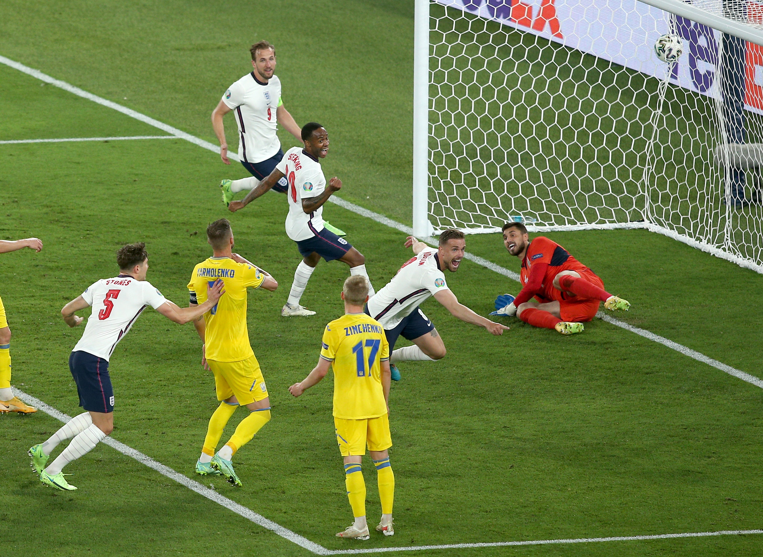 Jordan Henderson, centre right, wheels away in celebration after his first international goa