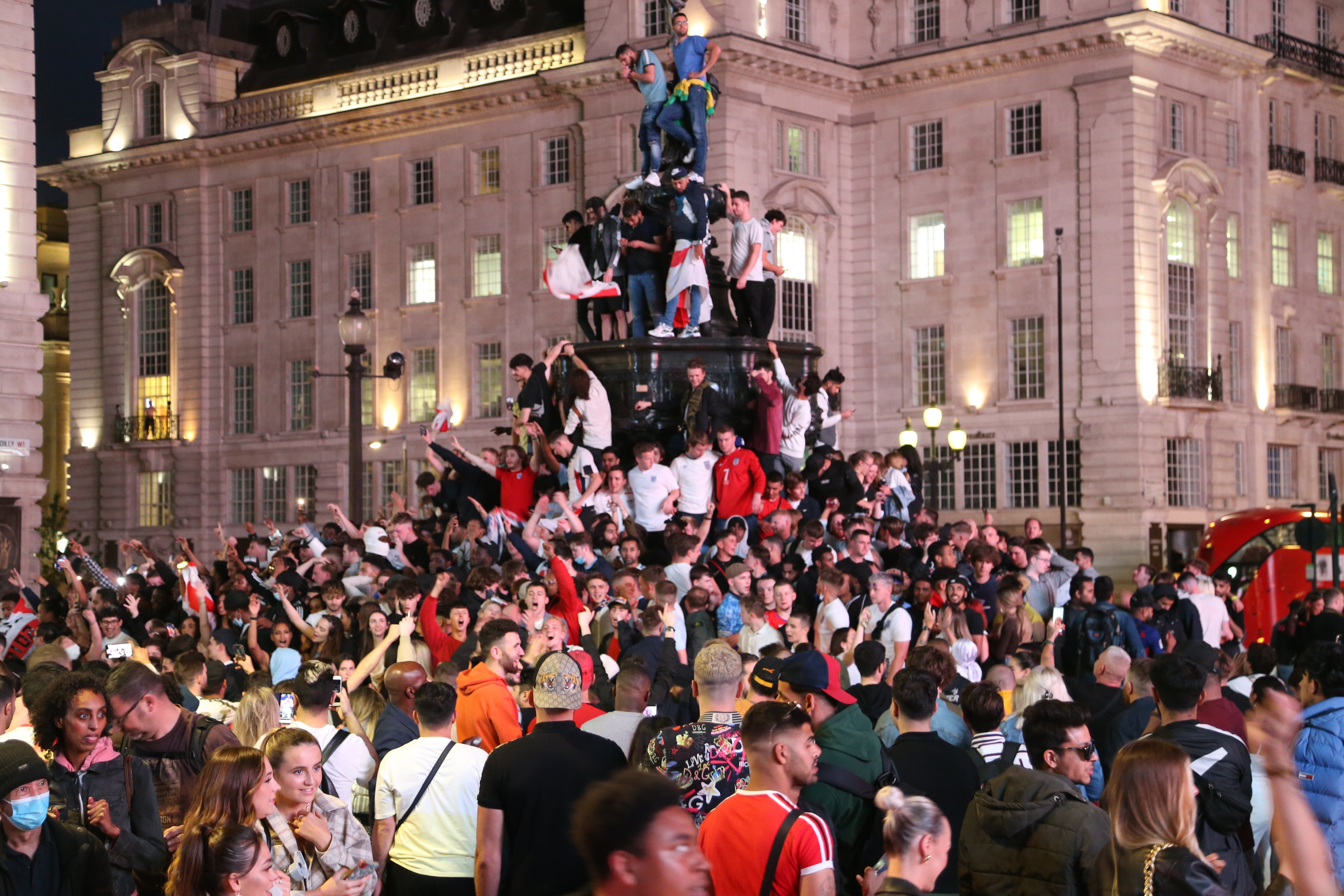 <p>Fans seen climbing the Shaftesbury memorial fountain in Piccadilly Circus, following England’s win against Ukraine</p>