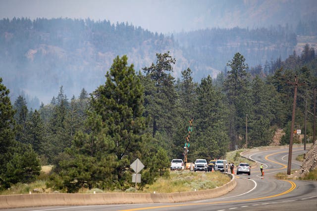 <p>Royal Canadian Mounted Police (RCMP) officers man a roadblock on the Trans-Canada Highway as a wildfire burns in Lytton, British Columbia, Friday, July 2, 2021. Officials on Friday hunted for any missing residents of a British Columbia town destroyed by wildfire as Canadian Prime Minister Justin Trudeau offered federal assistance. </p>