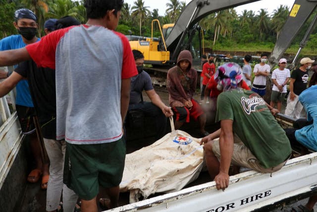 <p>This photo taken on 4 July, 2021 shows people on board a truck accompanying a body bag containing the remains of a person killed in a Philippine Air Force C-130 plane crash near the airport in Jolo town, Sulu province on the southern island of Mindanao. </p>