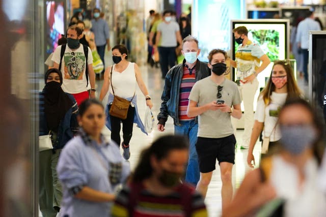 <p>Shoppers in masks</p>
