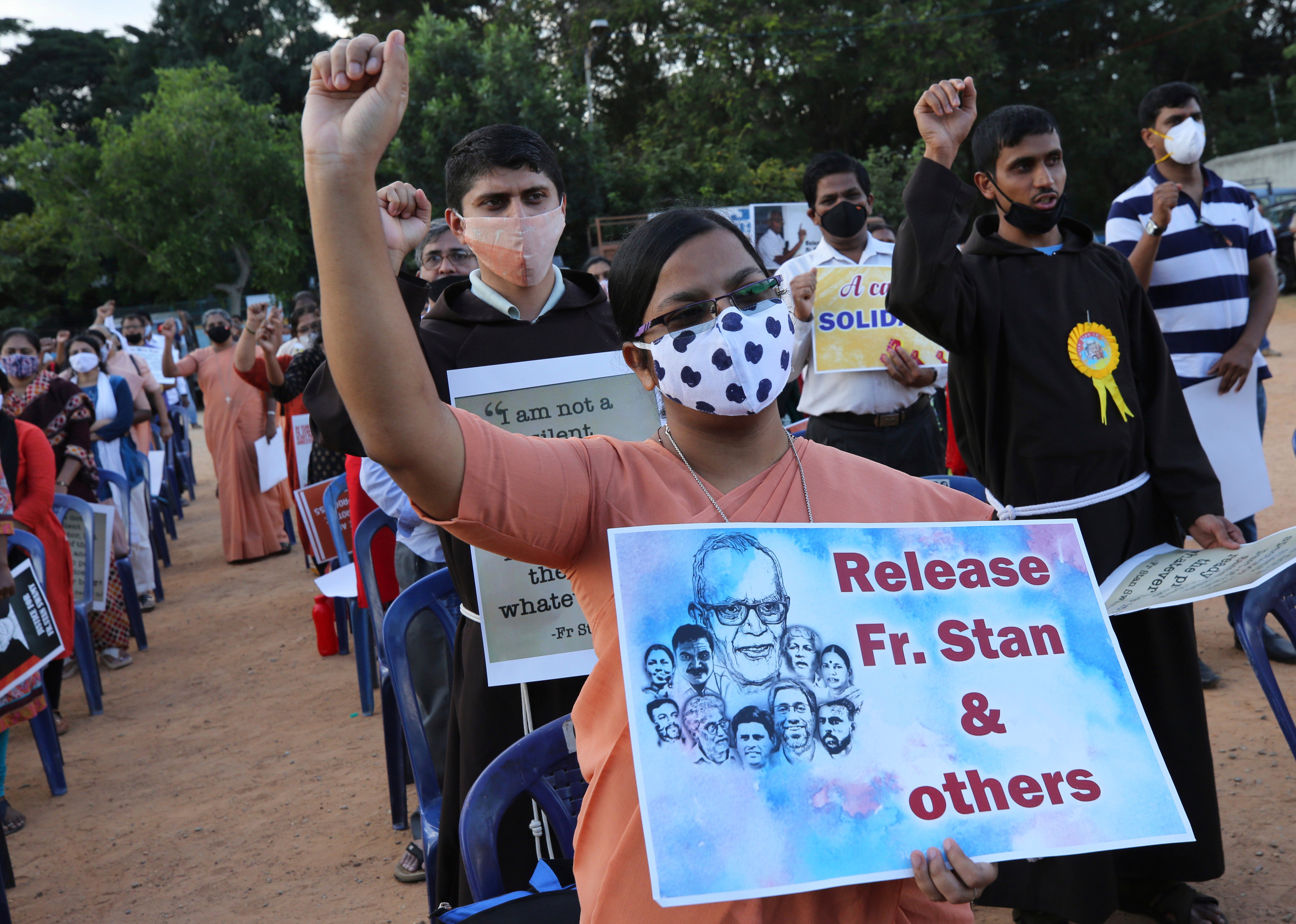 File photo: A Christian nun, center, holds a placard and shouts slogans with others demanding the release of tribal rights activist Stan Swamy and other activists during a demonstration in Bengaluru, India, in November 2020