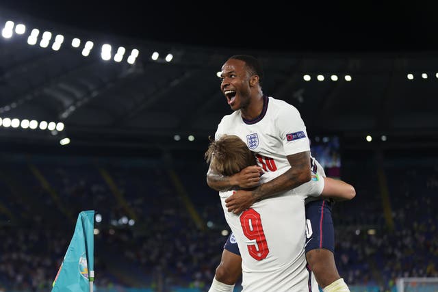 <p>Raheem Sterling celebrates with England captain Harry Kane</p>