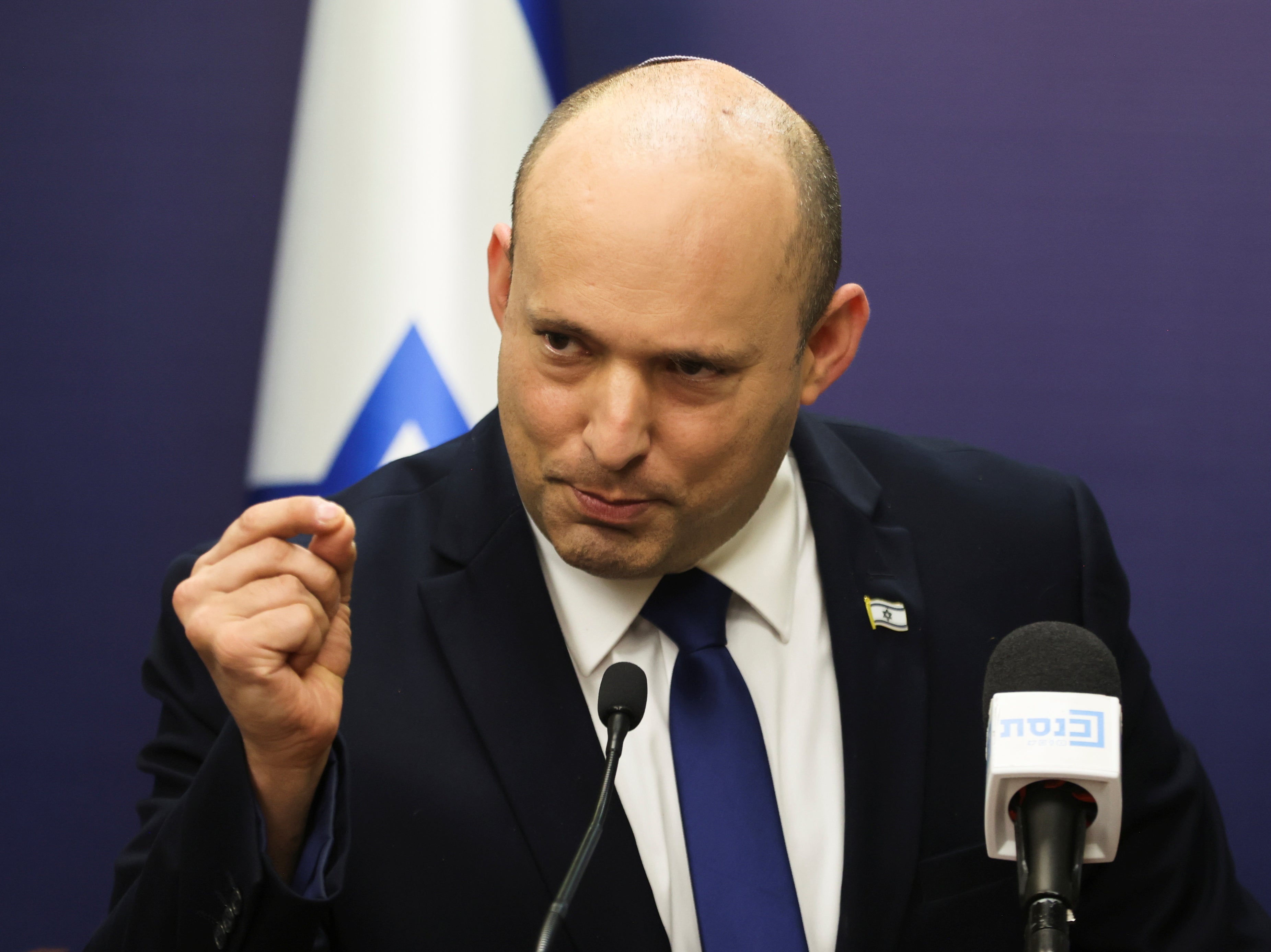 Israeli Prime Minister Bennett gestures as he speaks during his party faction meeting at Israel’s parliament in Jerusalem
