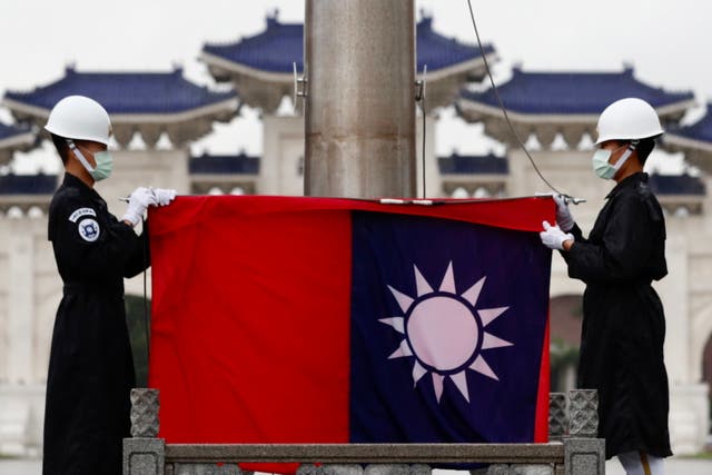 <p>Taiwanese honor guards fold Taiwan flag during a Flag Lowering in Taipei, Taiwan, 22 June 2021 (issued 28 June 2021)</p>