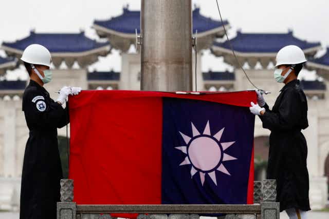 <p>Taiwanese honor guards fold Taiwan flag during a Flag Lowering in Taipei, Taiwan, 22 June 2021 (issued 28 June 2021)</p>
