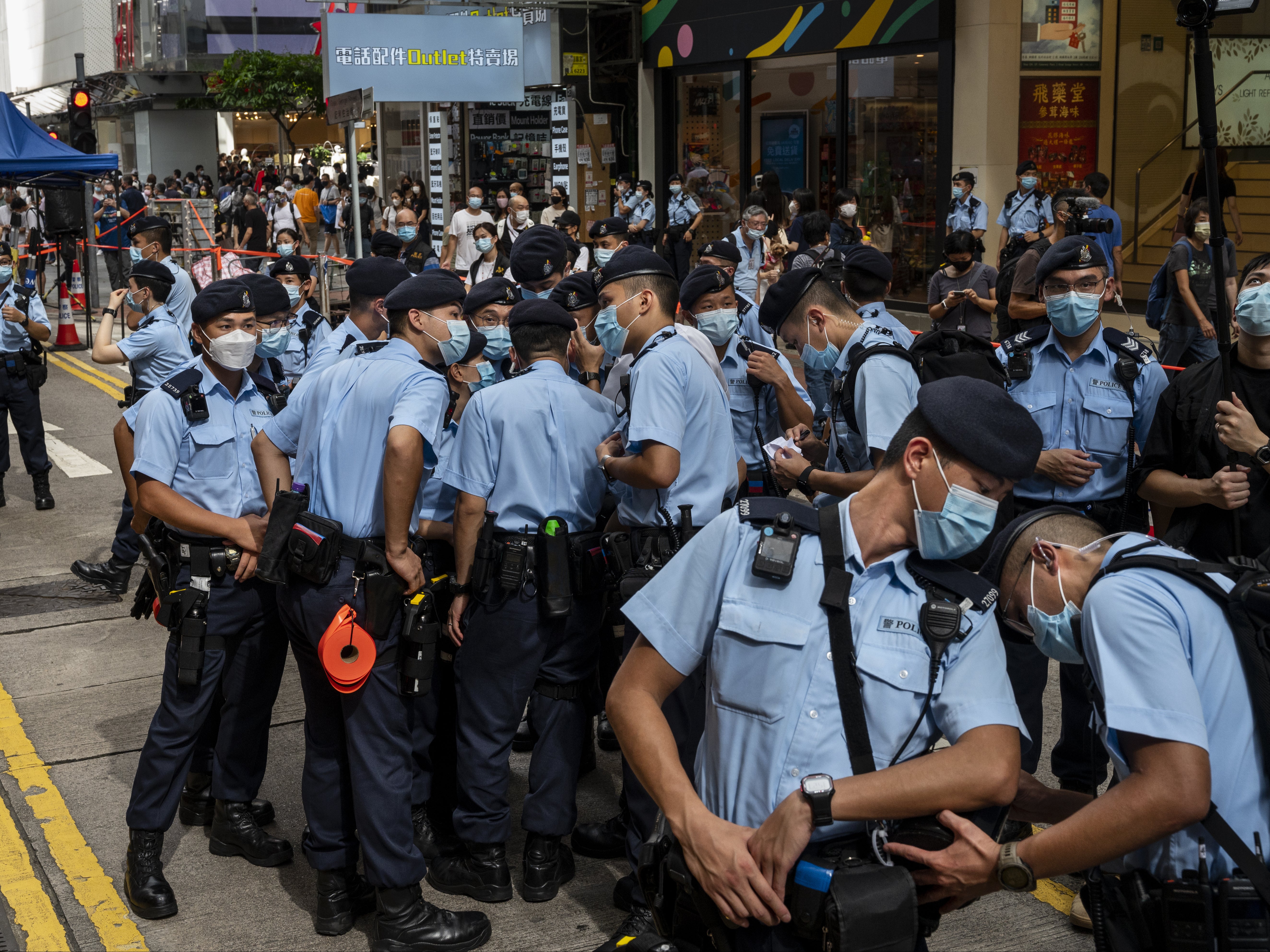 Police officers stand guard in Hong Kong on July 1, 2021