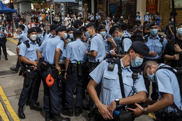 <p>Police officers stand guard in Hong Kong on July 1, 2021</p>