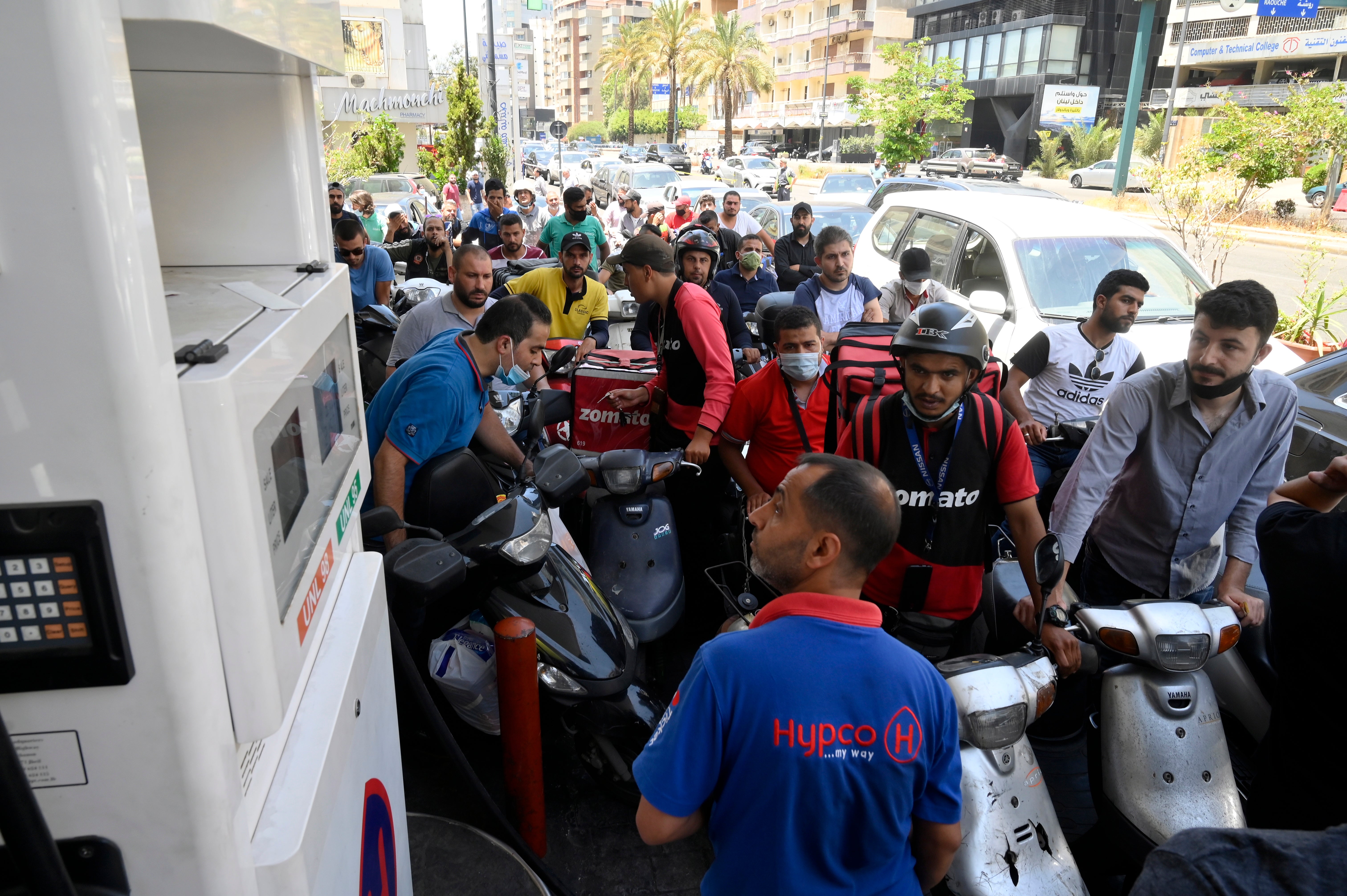Motorists crowd a petrol station to get fuel as supplies are rationed