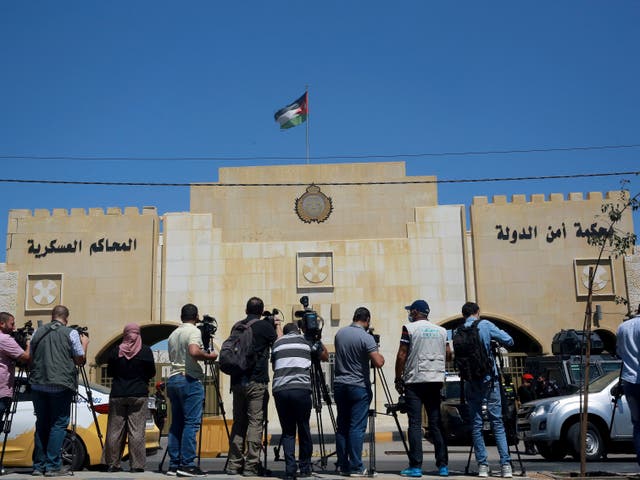 <p>Reporters stand outside the state security court </p>