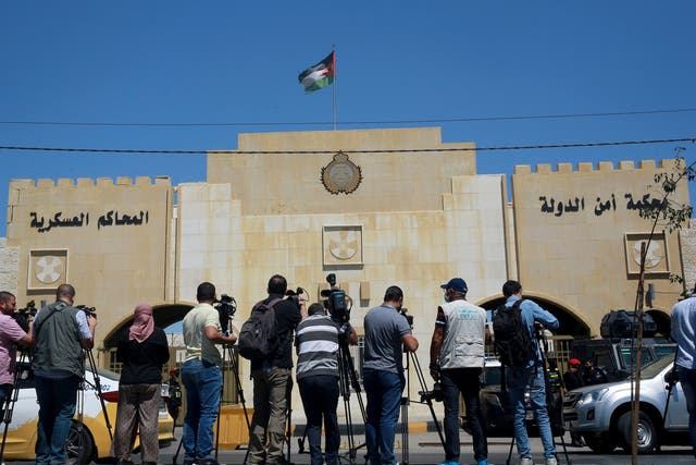<p>Reporters stand outside the state security court </p>