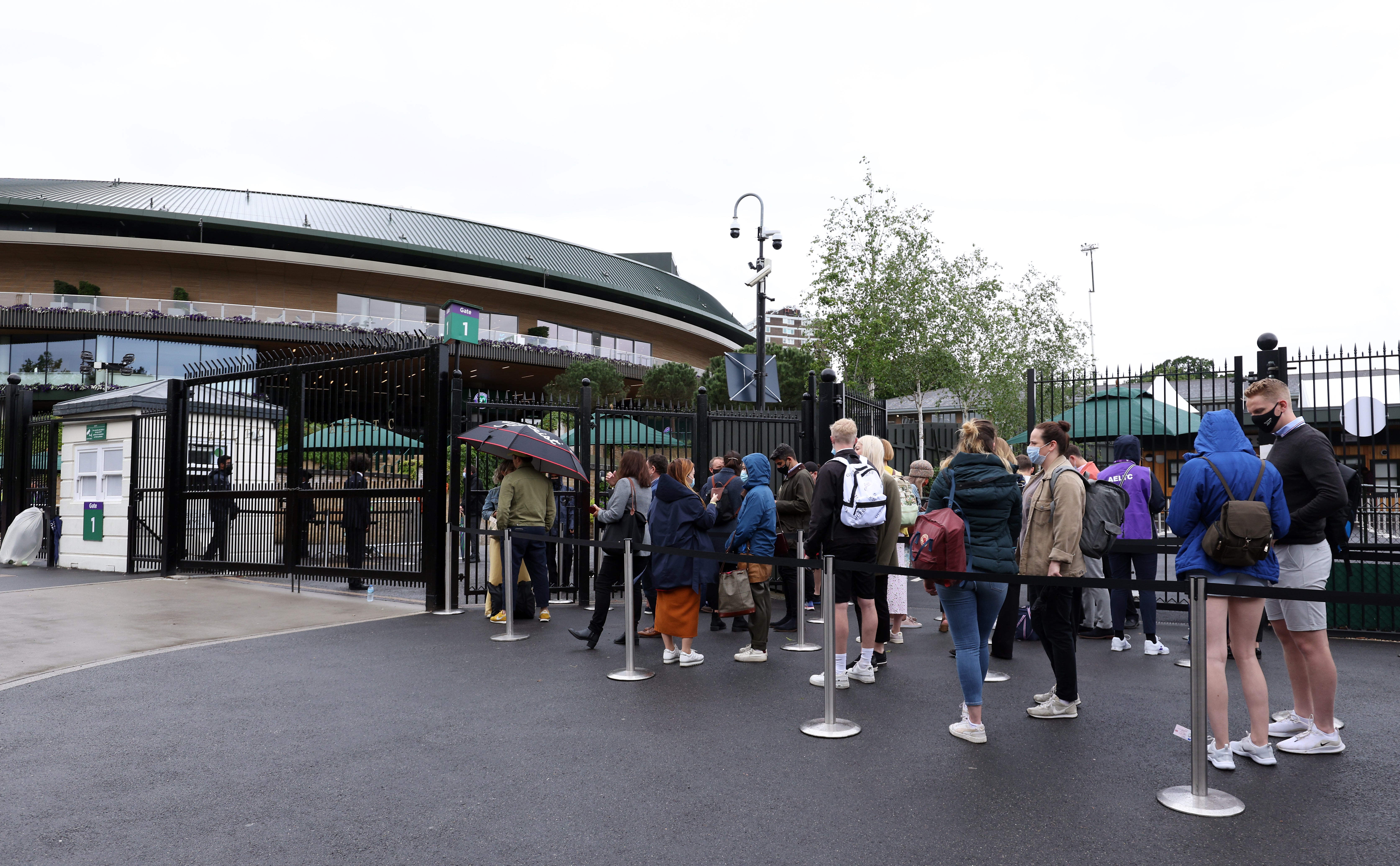 Tennis fans queue to enter the grounds on day eight of Wimbledon