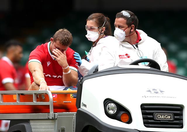 <p>Leigh Halfpenny, left, leaves the pitch on a medical cart against Canada</p>