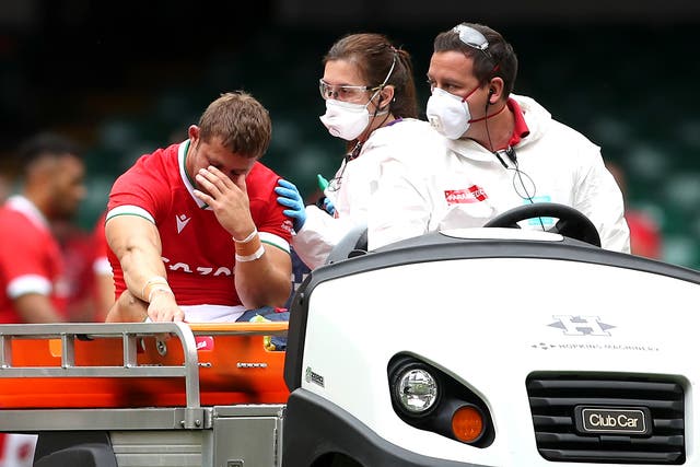 <p>Leigh Halfpenny, left, leaves the pitch on a medical cart against Canada</p>