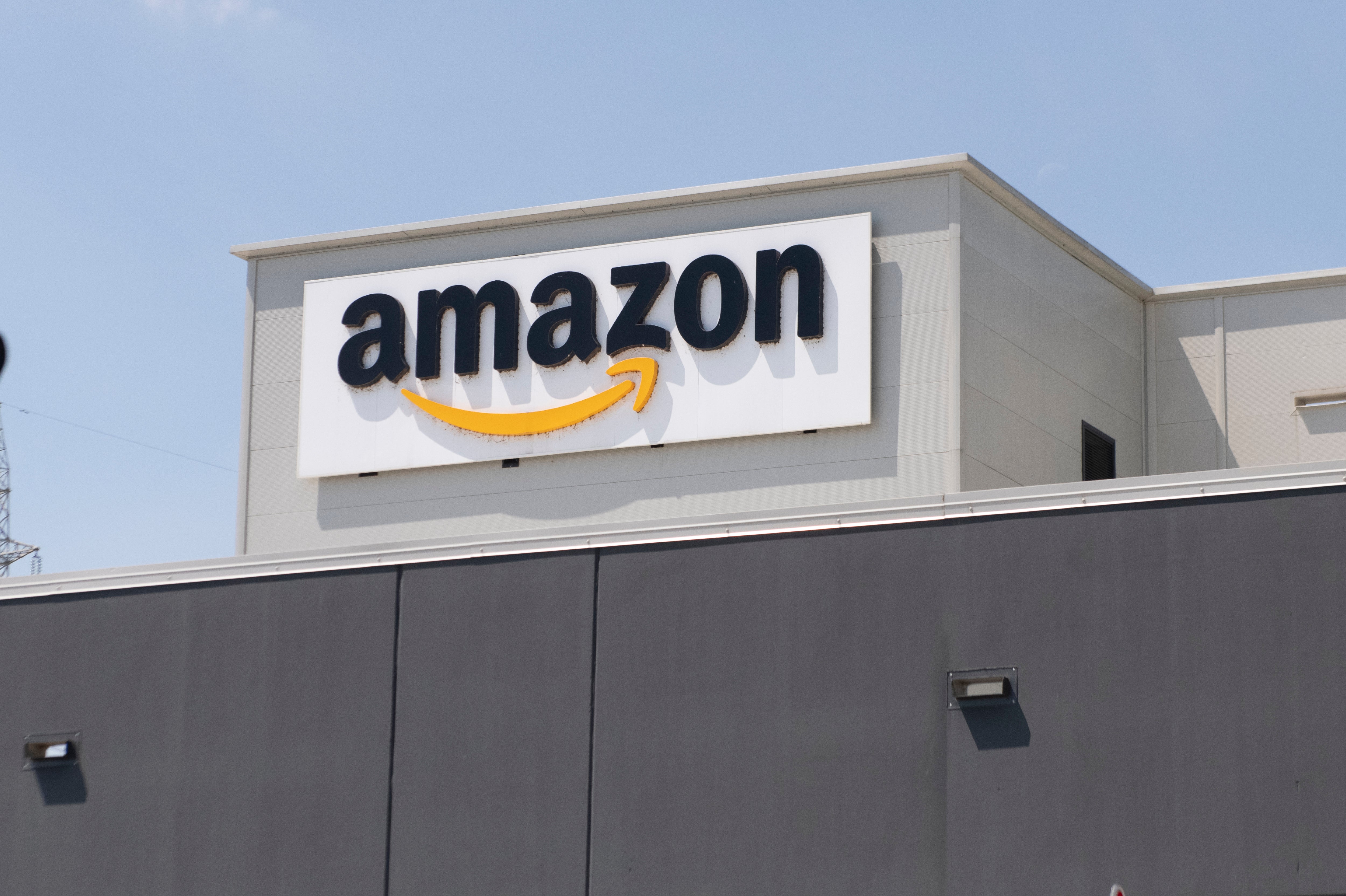 The Amazon logo can be seen at a location in Torrazza Piemonte near Turin, Italy 3 June, 2021. The company’s median worker reportedly made less than $30,000 last year.