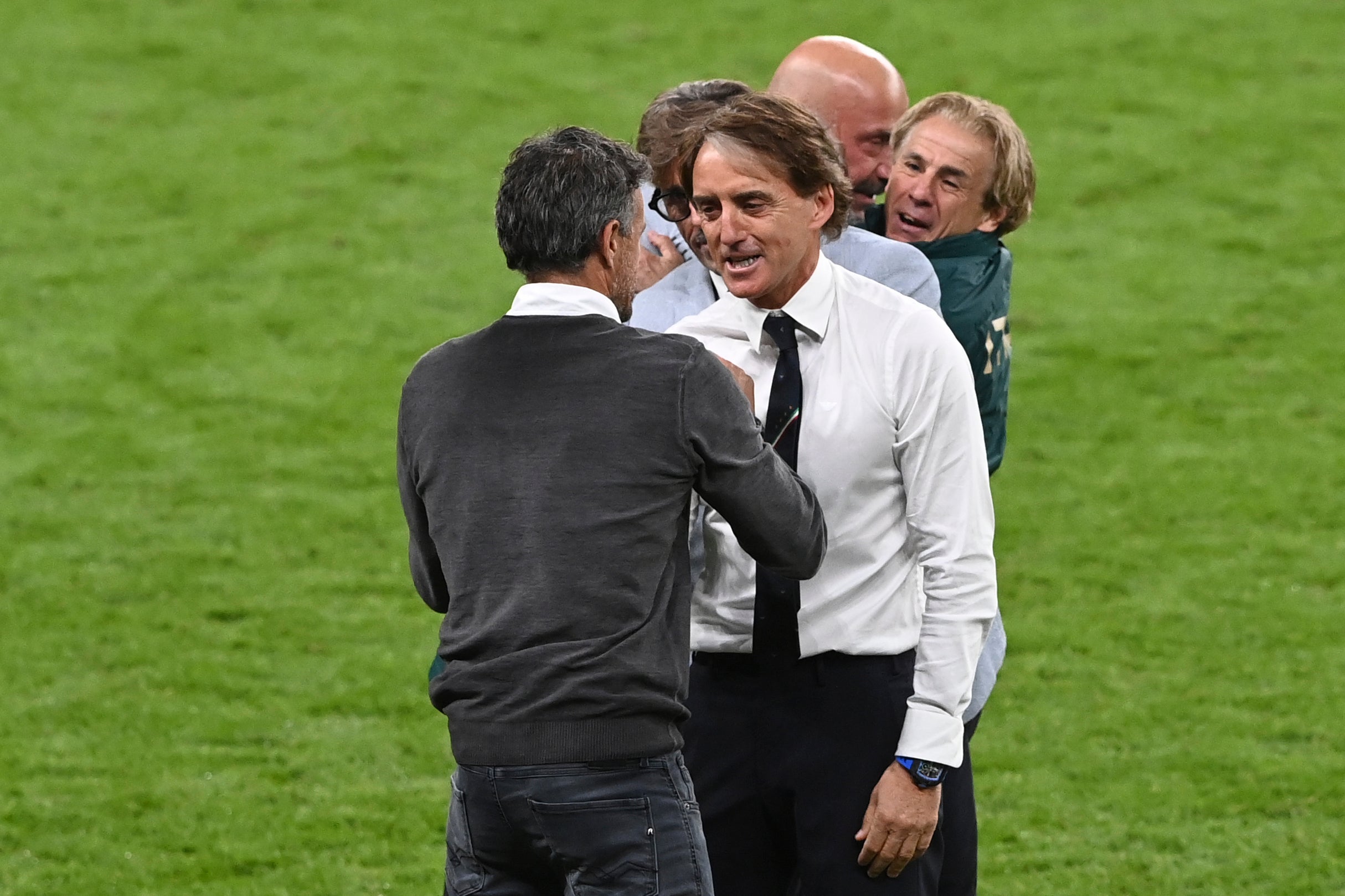 Roberto Mancini, right, greets Spain manager Luis Enrique after the game