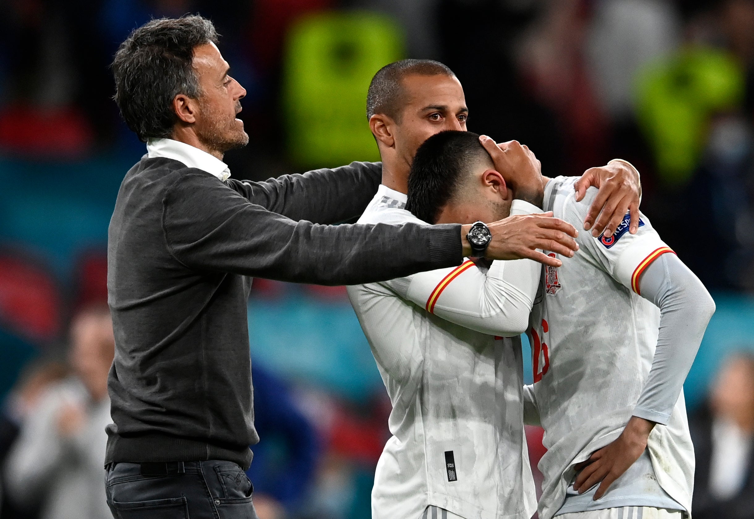 Luis Enrique, left, consoles his beaten players