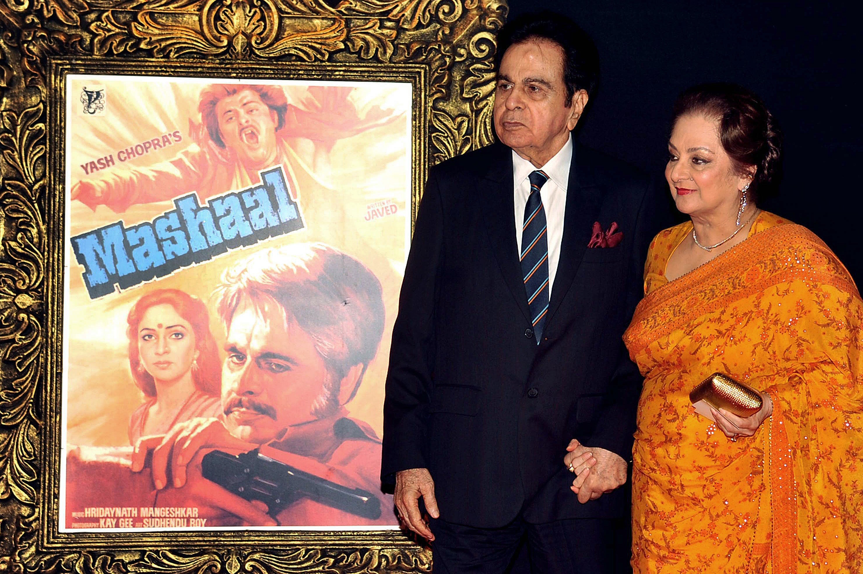 Indian Bollywood film actor Dilip Kumar (L) and his wife Saira Banu pose on the red carpet at a film premiere in 2012