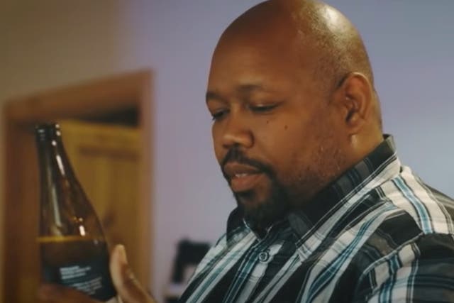 <p>A screenshot from the ad by the Polish brewery showing a Black bar man having a beer called ‘White IPA Matters’ surrounded by symbols from the US’s deep south</p>