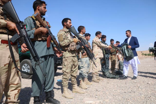 <p>Afghan security officials stand guard against the Taliban during a ceremony in Herat, near Badghis province </p>