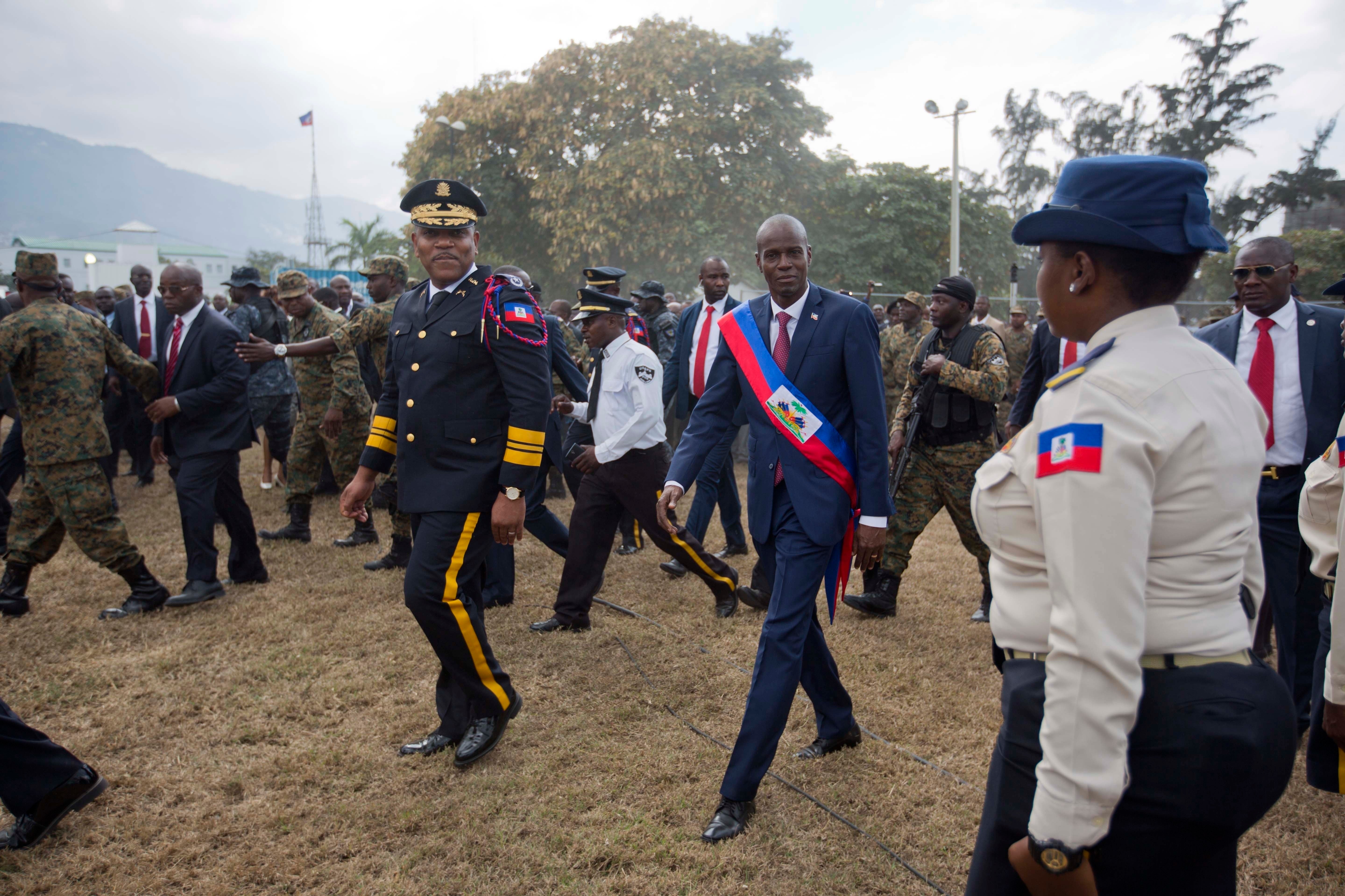 Newly sworn-in Haitian President Jovenel Moise walks with Police Chief Michel-Ange Gedeon past National Police at the National Palace after his inauguration ceremony in 2017