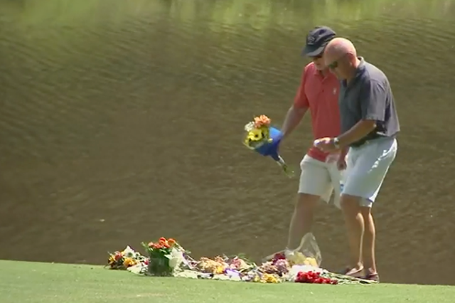 <p>Golfers pay their respects on the 10th green of the Pine Country Club course where Gene Siller was shot dead</p>